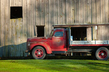 Vintage International Flatbed Truck And Old Wooden Barn. Viewed In The Agricultural Capital Of Western Washington State-the Skagit Valley. Brings Back Memories Of Time Gone By.