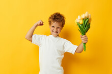 Photo Portrait Curly Little Boy With Yellow Flowers Posing Childhood Fun Color Background Unaltered