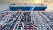Aerial view vehicle carrier vessel loading car for shipping to worldwide, Large RoRo (Roll on/off) vehicle car carrier, New car lined up in the port for import export around the world.
