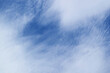 Amazing white altostratus clouds spreading across vibrant blue sky