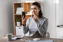 Medicine, Quarantine And Pandemic Concept - Woman With Swab And Smartphone Taking Sample From Her Nose And Making Nasal Coronavirus Self Test At Home