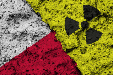 Concept of the Nuclear Energy Policy of Poland with a flag and a radiation hazard sign painted on a rough wall