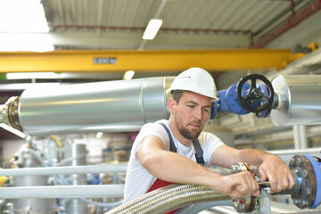 Mechanics repair a machine in a modern industrial plant - profession and teamwork