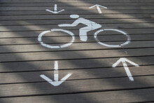 Two-way Bicycle Sign Painted On A Wooden Walk