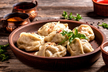 Wall Mural - Traditional manti food on plate, top view. The concept of oriental cuisine. Uzbek food manty dumplings. Uzbek food. banner, catering menu recipe place for text