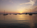 Fototapeta Pomosty - Sunset at the sea near yacht port