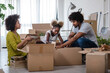 © lordn - Happy playful African American family moving in new apartment, unpacking, moving stuff, purchase property concept