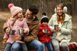 © New Africa - Happy family with hot drinks spending time together in forest