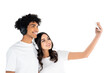 cheerful interracial couple in headphones taking selfie on mobile phone isolated on white.