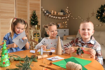 Wall Mural - Cute little children making beautiful Christmas greeting cards at home