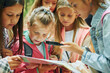 © standret - With map. Kids in green forest at summer daytime together