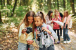 © standret - Conception of tourism. Kids in green forest at summer daytime together