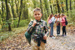 © standret - Conception of hiking. Kids in green forest at summer daytime together