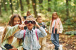 © standret - Front view of kids that is in green forest at summer daytime together