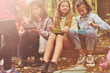© standret - Sitting and having a rest. Kids in green forest at summer daytime together