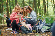 © standret - Sitting and having a rest. Kids in green forest at summer daytime together