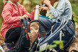 © standret - Two people sitting and resting. Kids in green forest at summer daytime together