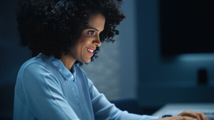 Poster - Successful African American Businesswoman Working on Laptop Computer in Big City Office Late in the Evening. Female Executive Manager Analyzing Financial Reports, Marketing Research and Plans.