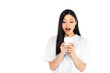 © LIGHTFIELD STUDIOS - astonished asian woman in t-shirt looking at mobile phone isolated on white.