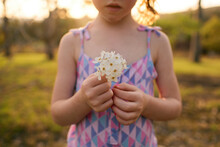 Close Up Of A Young Girl Holding White Flowers