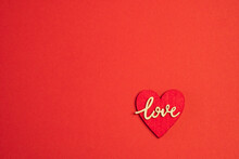 A Red Heart Shaped Decoration And Word LOVE On A Red Background