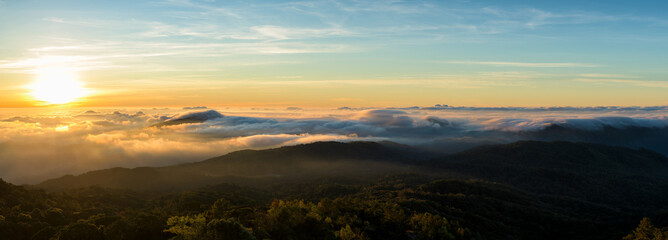 Wall Mural - panoramic of foggy at morning, mountains top view of sunrise landscape in the rainforest.