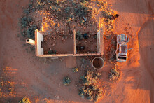 Aerial View Of The Shell Of An Old House And Car Wreck Alongside