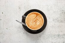 Top Shot Of A Coffee In A Black Cup On White Marble Background