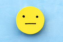 Yellow Discreet Smiley Face On A Blue Background. The Concept Of Mood Selection And Customer Feedback.