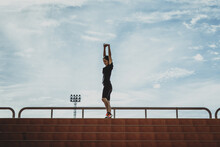 Running Woman Stretching During Morning Exercise On The Stadium Stairs Health Care Concept