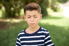 Beautiful Caucasian Little Kid Boy Wearing Stripped T-shirt Standing Outdoors Nice-looking Sweet Charming Cute Attractive Lovely Winsome Sweet Peaceful Closed Eyes