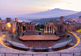 Fototapeta  - Sunset on the ancient roman-greek amphitheater with the Giardini Naxos bay in the back in Taormina, Sicily, Italy