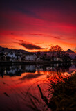 Fototapeta Na sufit - Fire Sunset over Interlaken
A beautiful, fiery sunset over one of the rivers in Interlaken, with some residential houses along the river. 