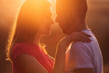 Couple On Sunset Have Romantic Kiss On Summer Day