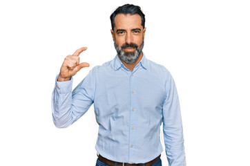 Sticker - Middle aged man with beard wearing business shirt smiling and confident gesturing with hand doing small size sign with fingers looking and the camera. measure concept.