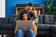 © Krakenimages.com - Man and woman couple hugging each other using laptop at home