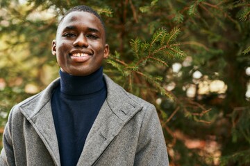 Young african american man smiling happy standing at the park.