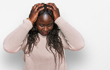 Sticker - Young african woman wearing wool winter sweater suffering from headache desperate and stressed because pain and migraine. hands on head.