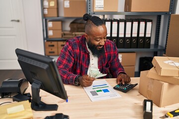 Sticker - Young african american man ecommerce business worker counting dollars at office