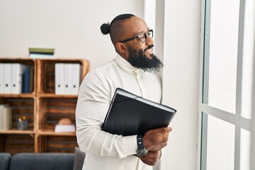 Sticker - Young african american man psychologist holding binder at psychology center