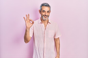 Sticker - Handsome middle age man with grey hair wearing casual shirt smiling positive doing ok sign with hand and fingers. successful expression.