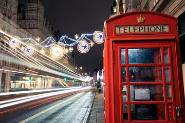 Sticker - Red telephone booth in Strand during Christmas season in London. England