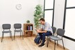 © Krakenimages.com - Young hispanic man using smartphone sitting on chair at waiting room