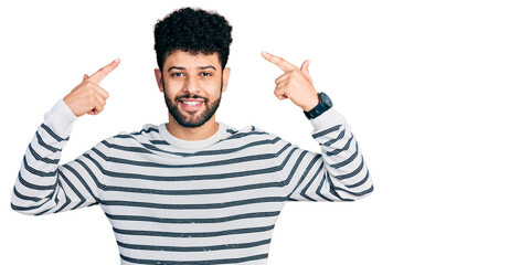 Sticker - Young arab man with beard wearing casual striped sweater smiling pointing to head with both hands finger, great idea or thought, good memory