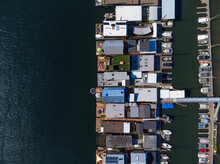 Shooting From The Air. There Are Many Small Houses And Water Transport. Moored Boats, Yachts, Ships. Sea Trade, Fishing, Water Walks, Outdoor Activities, Sports. Color Image.