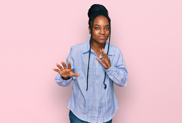 Wall Mural - Young african american woman wearing casual clothes disgusted expression, displeased and fearful doing disgust face because aversion reaction. with hands raised