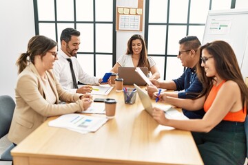 Wall Mural - Group of hispanic business workers smiling happy working at the office