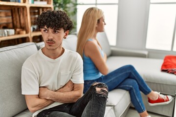 Sticker - Young couple angry sitting on the sofa in silence at home.