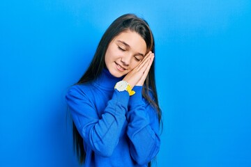 Sticker - Young brunette girl wearing turtleneck sweater sleeping tired dreaming and posing with hands together while smiling with closed eyes.