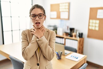 Poster - Young brunette teenager wearing business style at office shouting and suffocate because painful strangle. health problem. asphyxiate and suicide concept.